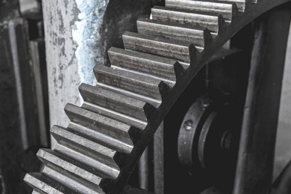 Steel huge gear. Flywheel from an old machine in a factory.Steel huge gear. Flywheel from an old machine in a factory.