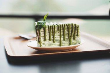 Close up delicios matcha green tea crape cake with fresh green t