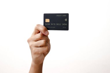 Temiz beyaz bir arkaplanda izole edilmiş siyah bir kredi kartı tutan bir elin yakın çekimi