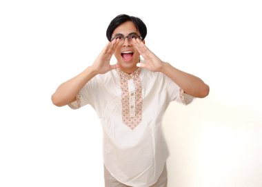 Heyecanlı Endonezyalı Müslüman adam beyaz arka planda izole edilmiş bağırıyor ve jestler yapıyor.