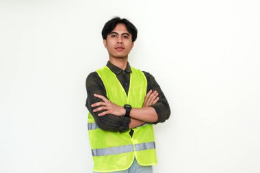 Asyalı kendine güvenen inşaat işçisi kollarını kavuşturup beyaz arka planda kameraya gülümsüyor. Endüstriyel, işçi ya da işe alım reklam temaları için mükemmel