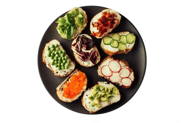 Sandwiches or tapas prepared with bread and tasty ingredients. Could be nice food for healthy breakfast ot lunch. Horizontal orientation.photo isolate — Stock Photo, Image
