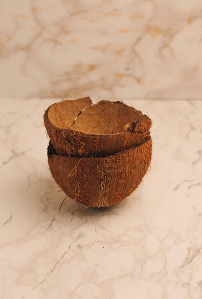 Deux moitiés d'une coquille de noix de coco sur un fond de marbre, isoler. Futurs bols de nourriture zéro déchet. Matériau écologique pour les ustensiles. Espace de copie . — Photo