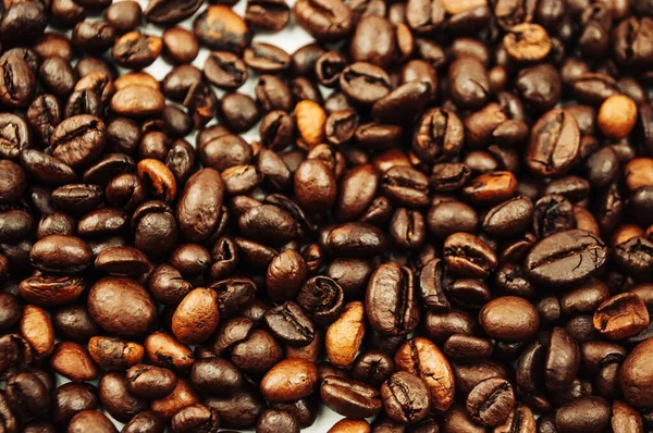 different types of roasted coffee beans texture background. The ingredient for a hot drink is Arab roast coffee. Freshly roasted brown coffee beans for background. Copy space. Top view.