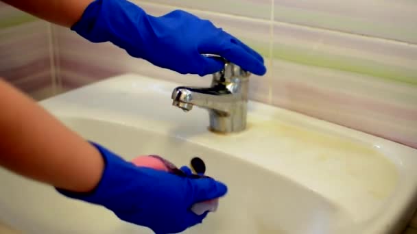 Mädchen in blauen Handschuhen wäscht das Waschbecken und putzt das Badezimmer. Haushälterin als Putzfrau am Waschbecken. Brush up Toilette für Sauberkeit und Hygiene. Reinigung des Waschbeckens. Reinigungsdienstkonzept — Stockvideo