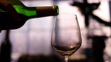 Red Wine Being Poured In Rainy Atmosphere, Red wine flows gracefully into a glass amidst a rainy backdrop, creating a moody ambiance, perfect for a romantic film scene or a sophisticated wine ad.