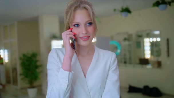 Stylish blonde talking on the phone, Stylish pretty woman, Girl with blue eyes. Smile while talking on a cell phone — Stock Video