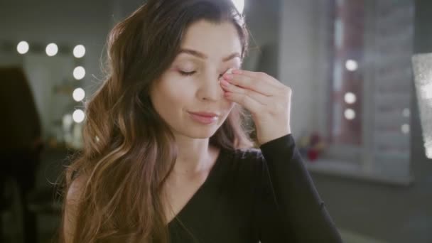 Una joven mujer se quita el maquillaje después de un duro día de trabajo. Feliz final del día, Eliminando Fundación de la cara — Vídeos de Stock