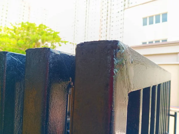 Arka plan olarak bulanık resim dairesi ve ağaçları olan siyah metal katlama kapısını kapat.