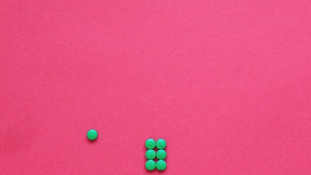 Animation of the movement of a Christmas tree made of green pills on a red — Stock Video