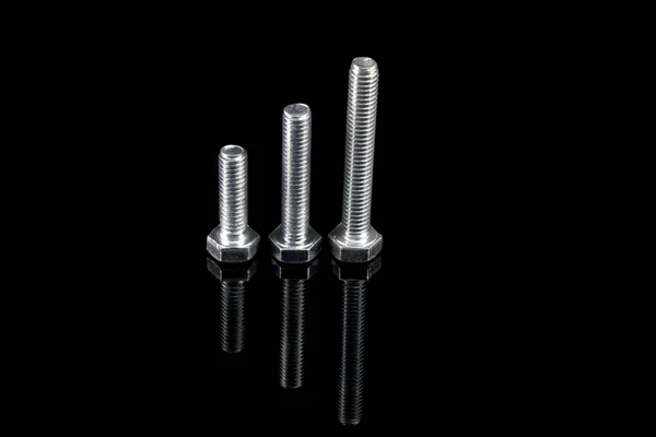 Metric hexagon head screws, Fasteners to the workshop. Reflection in black glass. — Stock Photo, Image