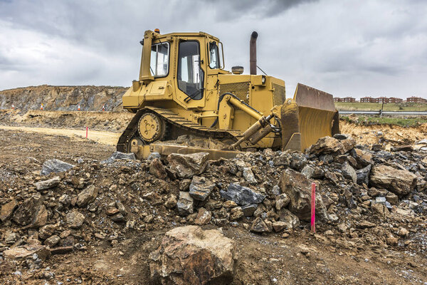 Excavator and heavy machinery for processing rock and stone in a quarry