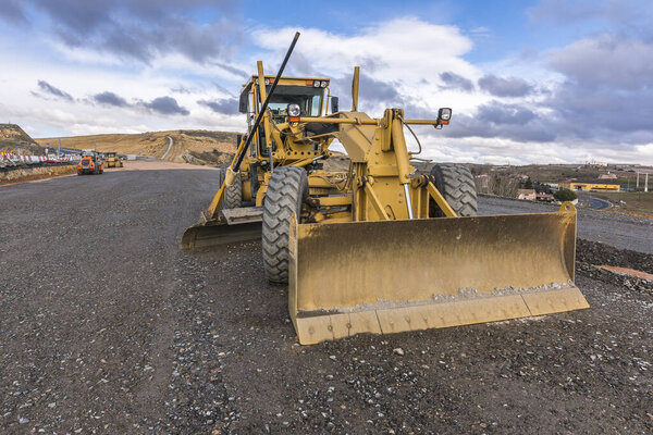 Motor grader in the construction work of a road