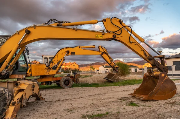 Excavator parked at an individual housing construction site