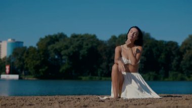 Genç bir kadın kumsalda güneşleniyor. Yaz tatili. Güzel bir kız vücudu. Güzel bir kızın vücudu sahildeki kumda dinleniyor..