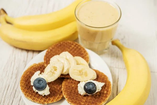 Wafers with blueberries and cheese and banana fresh. Different fruit and delicious breakfast.