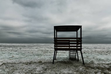 Deniz kıyılarının sert kış manzarası. Kurtarma kulesi ve donmuş deniz. Minimalist manzara. Odessa. Karadeniz.