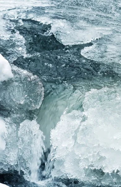 Buzulda su olan berrak bir dere. Buzul eriyor. Seçici yumuşak odak.