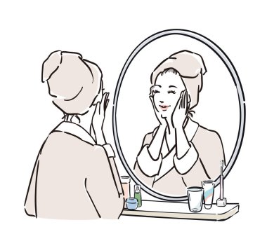 Aynanın önünde duran bornozlu kadınlar cilt bakımı