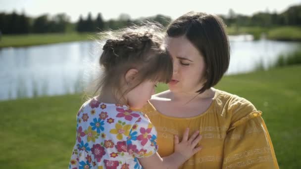 Mother kissing and cuddling with special daughter — Stock Video