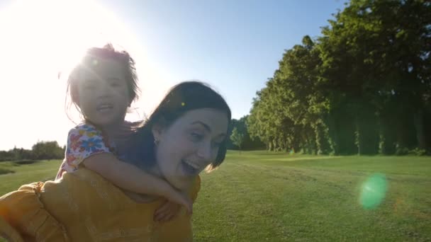 Aufgeregtes Mädchen lacht Mütter im Park an — Stockvideo