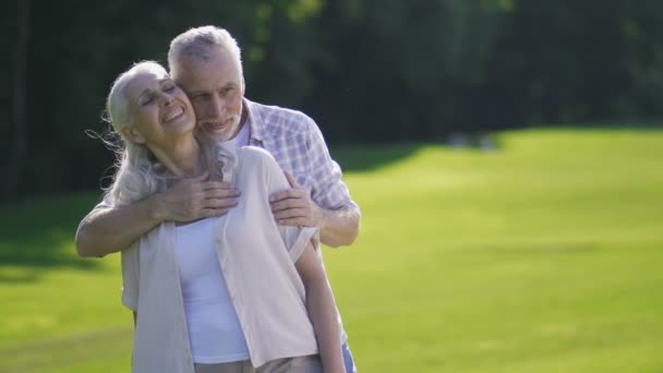 Portrét vášnivý starší pár na zeleném trávníku — Stock video