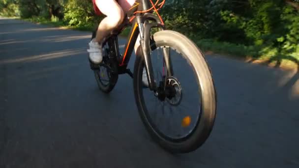 Closeup teenage girl cycling on bicycle outdoors — Stock Video