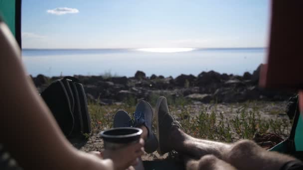 Close-up of couple in tent drinking coffee — Stock Video