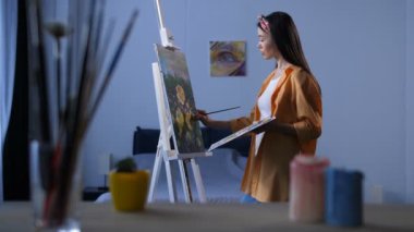 Güzel kadın ressam boyama çiçek bitirme