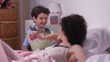 Neşeli oğlu Lale buketi sevgili annesine vererek