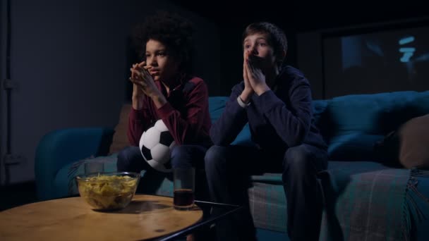 Soccer fan teens emotionally watching match on TV — Stock Video