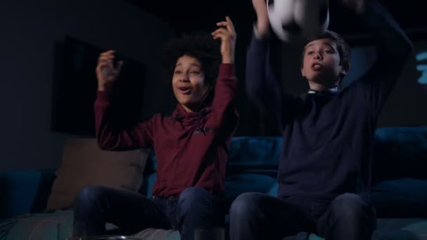Teen boys expecting goal watching football match — Stock Video