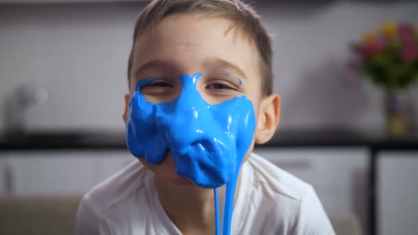 Adorable funny boy with face covered blue slime — Stock Video