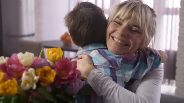 Closeup joyful mom tightly embracing beloved son — Stock Video