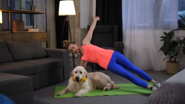 Deportiva mujer haciendo sidestand ejercicio con perro — Vídeos de Stock