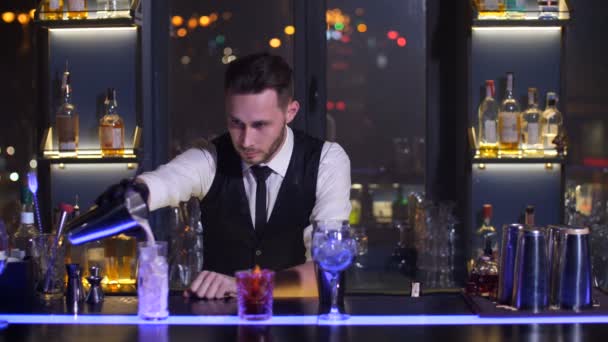 Cantinero vertiendo bebida de cóctel lista en vaso — Vídeos de Stock