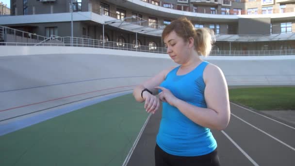 Mujer runnner opciones de elección en pulsera de fitness — Vídeo de stock