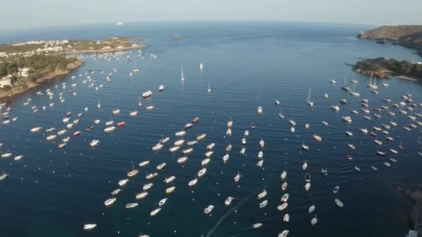 Drone flight over yachts in blue bay near Cadaques — Stock Video