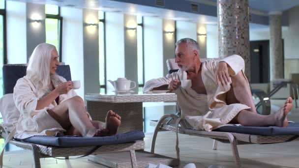 Happy aging couple spending vacation in spa hotel — Stock Video