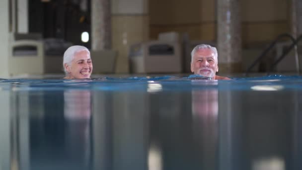 Aktív érett pár úszás a Spa Hotel medencéjében
