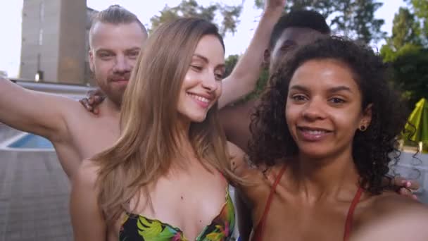 Cheerful diverse friends taking selfie near pool — Stock Video