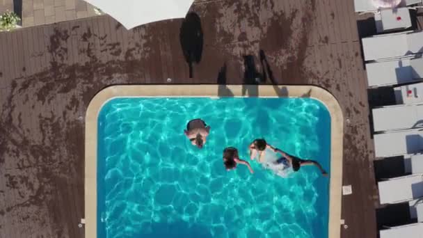 Top view of diverse young people jumping in pool — Stock Video