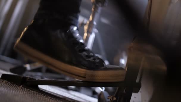 Leg of musician pressing foot pedal on drum set — Stock Video