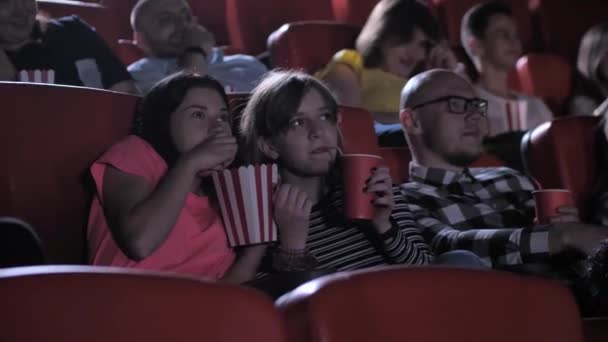 Adolescentes assistindo filme emocionante no cinema — Vídeo de Stock