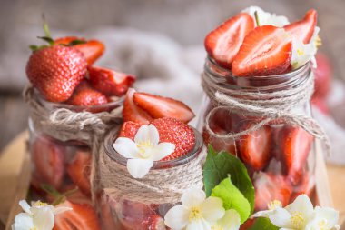 Kavanoz ahşap arka plan üzerinde taze çilek