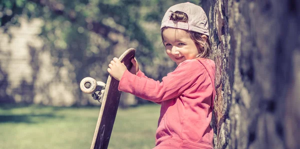 Ein Modisches Kleines Mädchen Hält Ein Skateboard Der Hand Und — Stockfoto