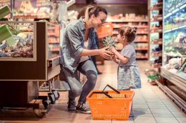 Aile ilişkileri ve sağlıklı beslenme kavramı süpermarkette alışveriş anne ve kızı