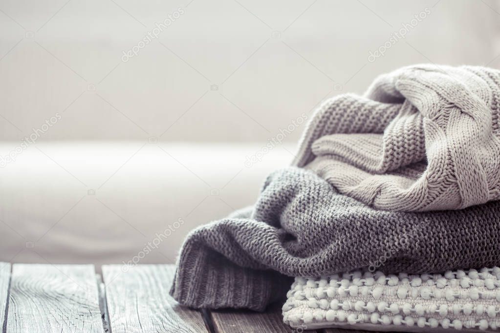 knitted sweater on a wooden table, space for text