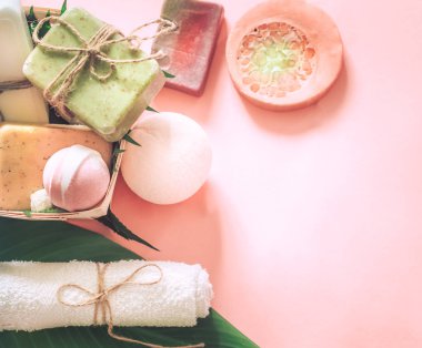 Tropikal spa kompozisyon sabun pembe bir arka plan, rahatlama ve vücut bakım kavramı tuz bombaları ile