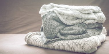 Metin için yer oturma odasında kanepede örme kazak yığını